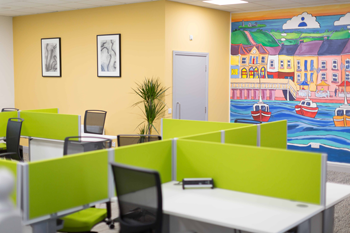 Kilrush Digital Hub hot-desks with artwork and mural in background