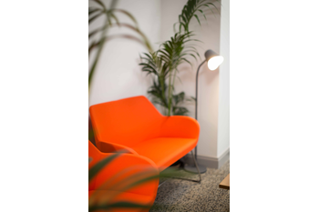 Orange armchair in the Kilrush Digital Hub with floor standing light behind it