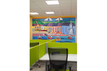 Kilrush Digital Hub hot-desk with bespoke mural painted by Dave O'Rourke in the background